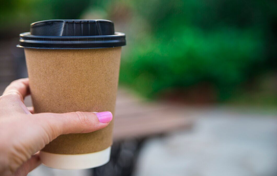 Close-up barista with gloves serving coffee